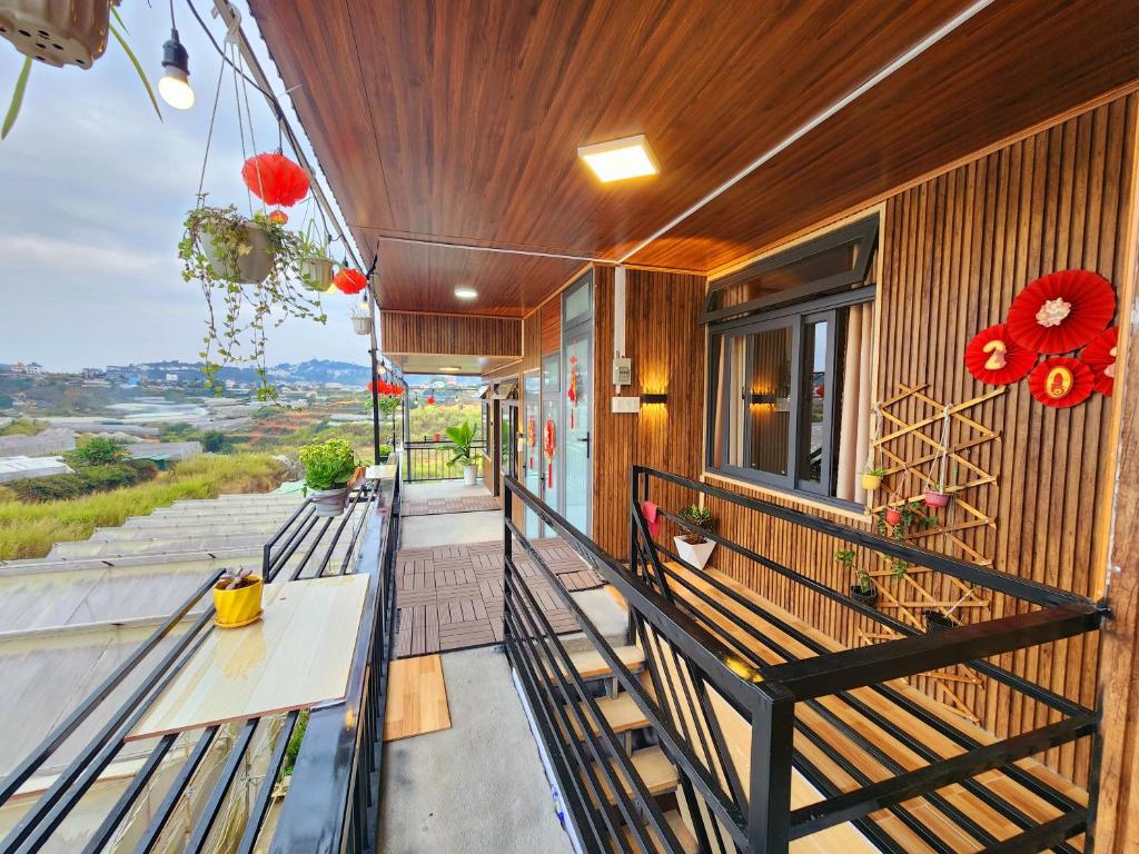 a balcony of a house with a bench at Xóm nhà lá homestay in Da Lat