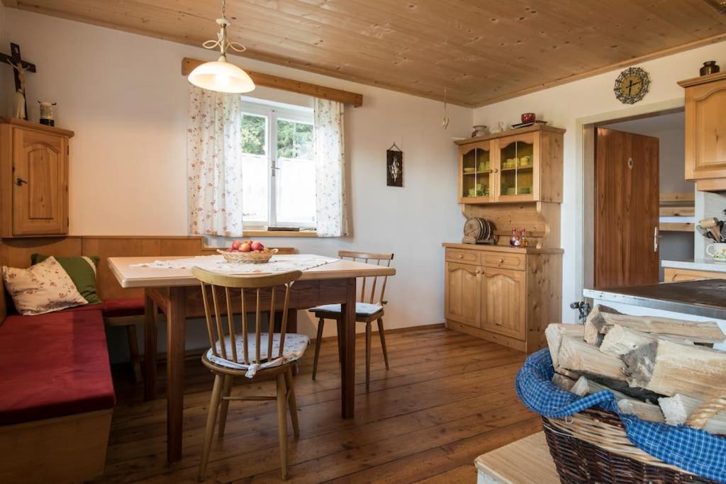 a kitchen with a table and chairs in a room at Brandner Almhütte in Schoberegg