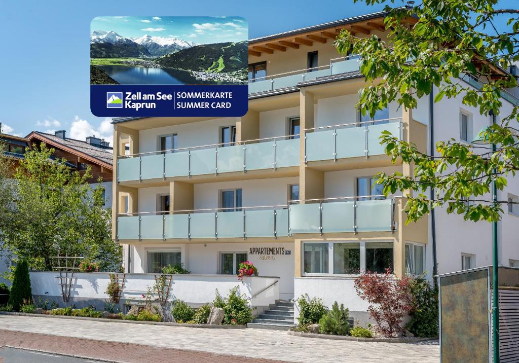a building with a sign in front of it at Appartements Sulzer by we rent, SUMMERCARD INCLUDED in Zell am See