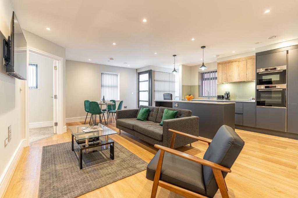 a living room with a couch and a table at Bond House by Celador Apartments in Reading