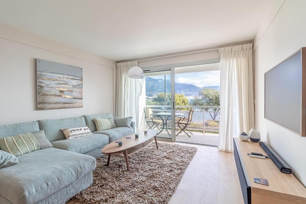 a living room with a couch and a table at Magnificent 2-room Apartment Sea View Roquebrune in Roquebrune-Cap-Martin