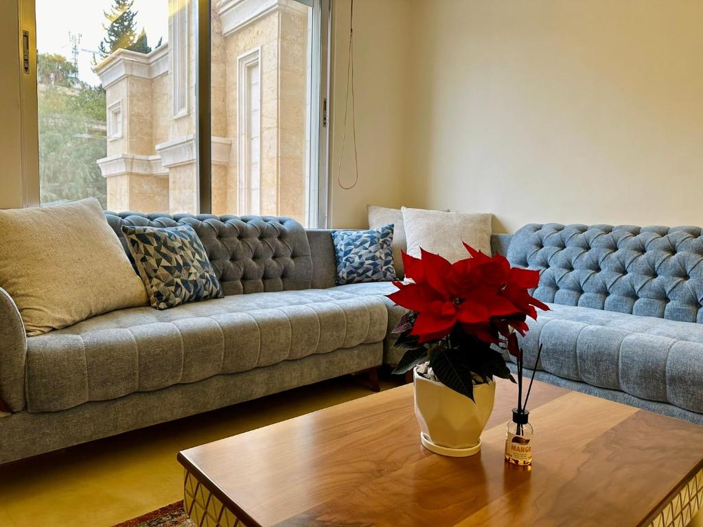 a living room with a couch and a table at Luxury Abdoun apartment in Amman