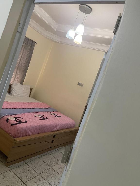 a small room with a bed in it at Best Yessit Homestay in Abuja