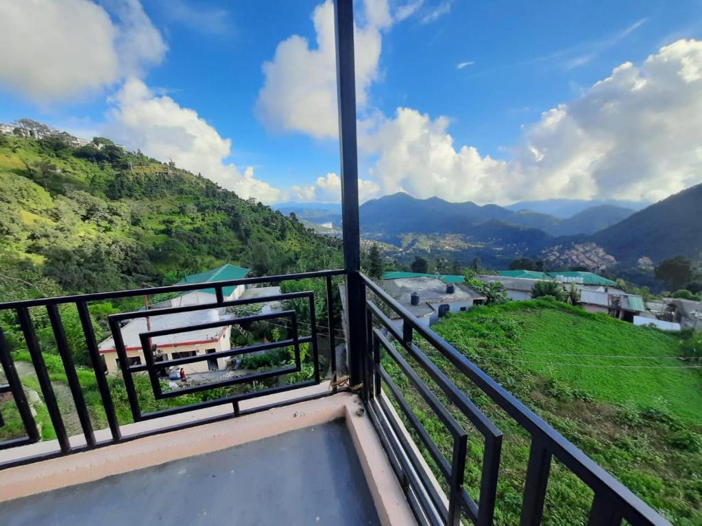 a balcony with a view of a mountain at Sadhna Holiday Home in Bhowāli