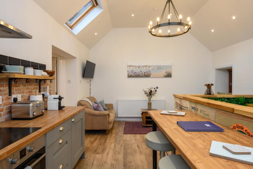 a kitchen with a counter top and a table at Old Town Loft in Cupar