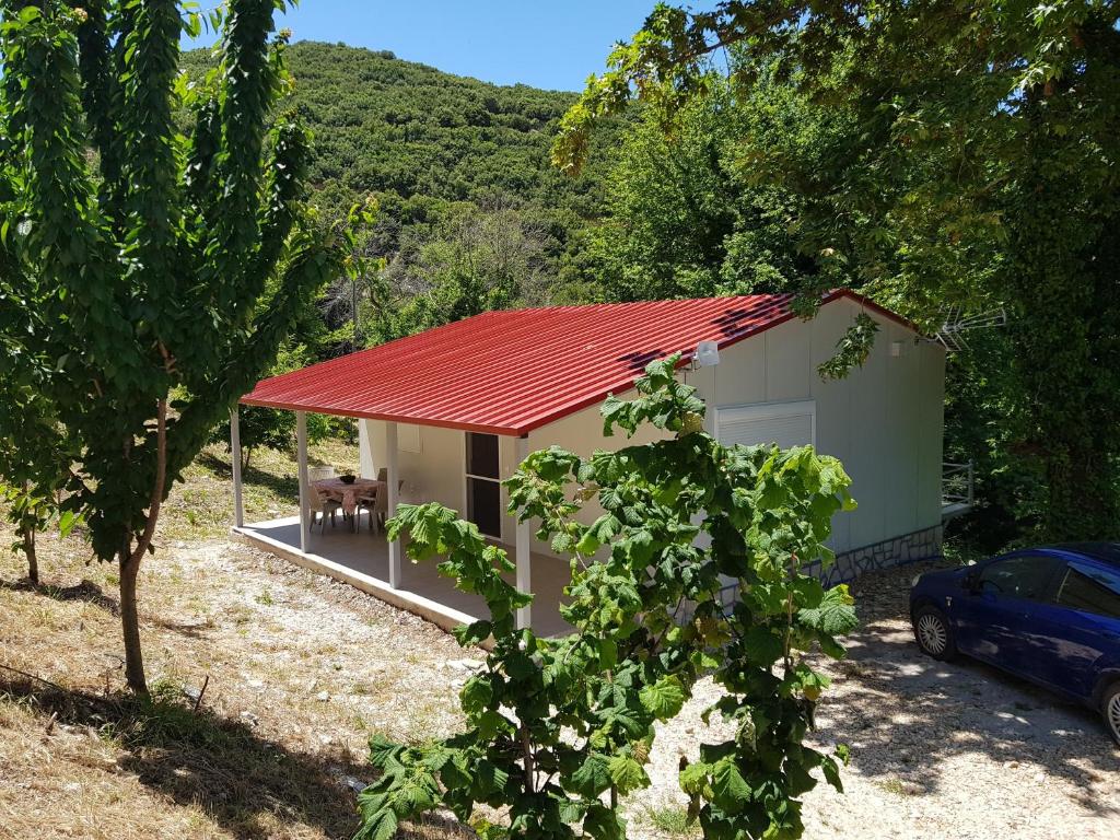 a small house with a red roof at Dimas House in Kanallaki