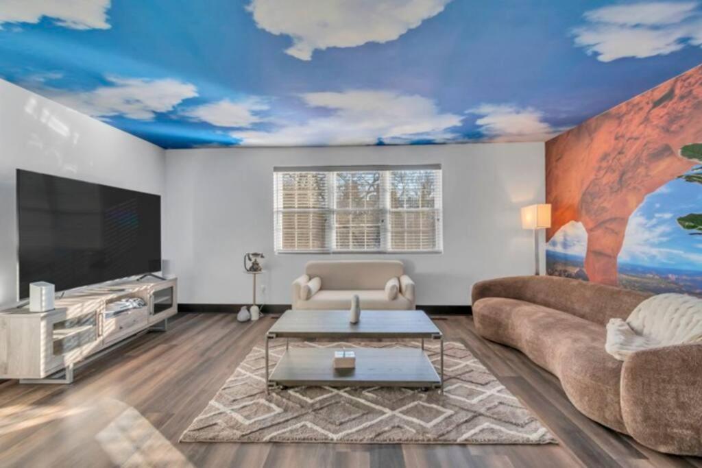 a living room with a couch and a tv at Roland park Customized Apartment in Baltimore