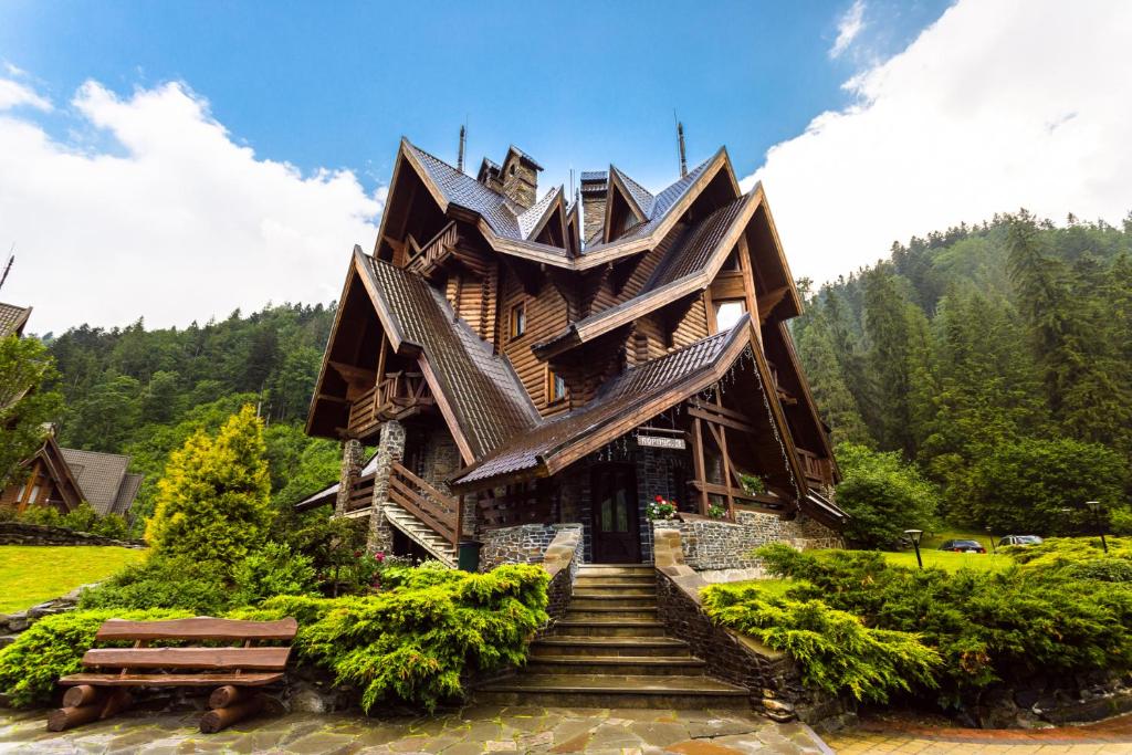 a wooden building with stairs leading up to it at Tsarynka Eco Complex in Slavske