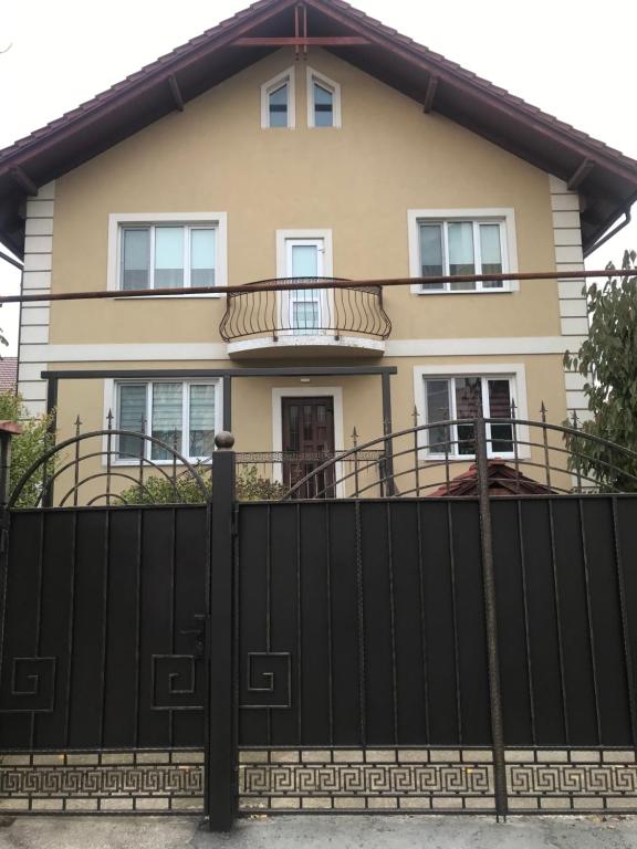 a house behind a black fence at Duplex in Chişinău