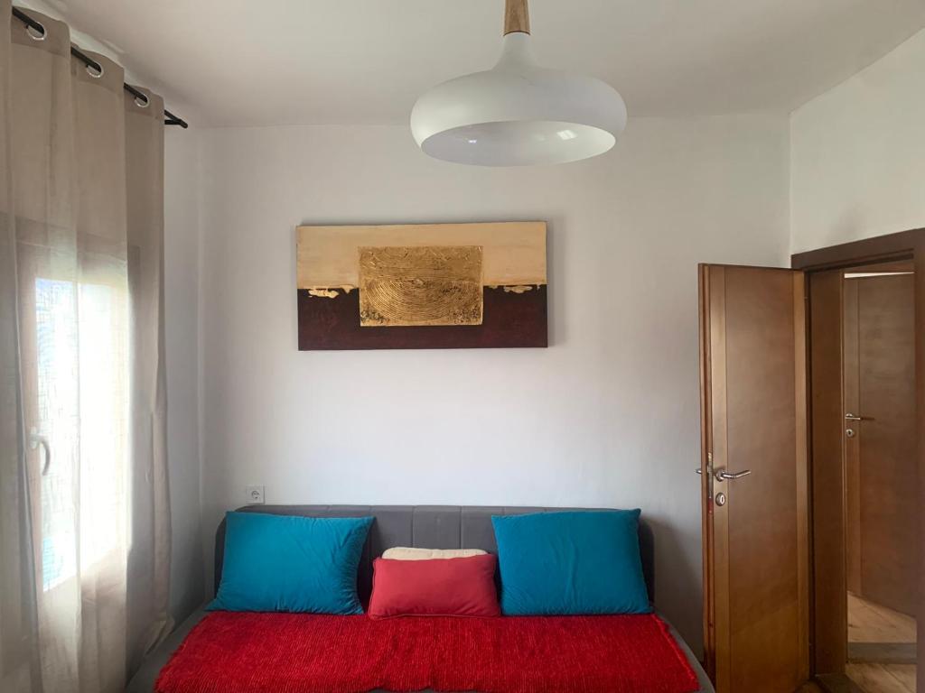 a room with a couch with two colorful pillows on it at Ethno guesthouse Tara in Mojkovac