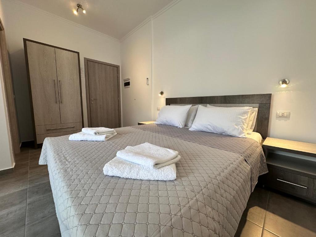 a bedroom with a large bed with towels on it at Vila Melina in Himare