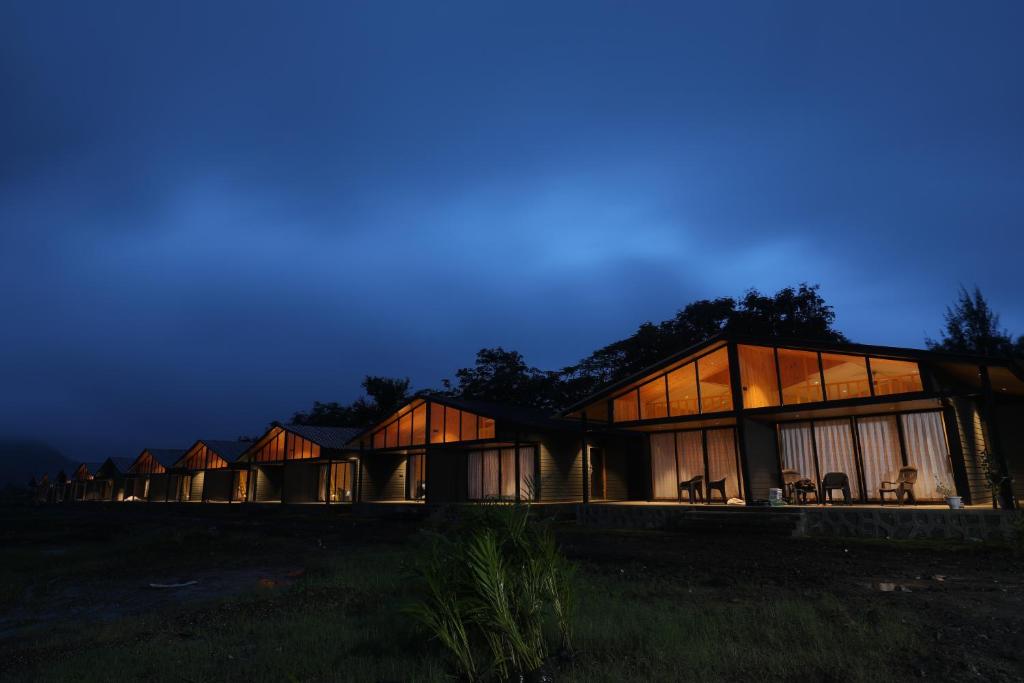 a row of lodges in a field at night at Shreephal luxurious Resort- Best resort in saputara in Saputara