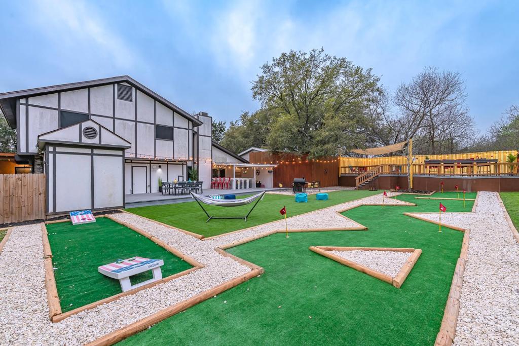 a large yard with a playground with at Pool, Gameroom & Minigolf Enchanting Texas Home in San Antonio
