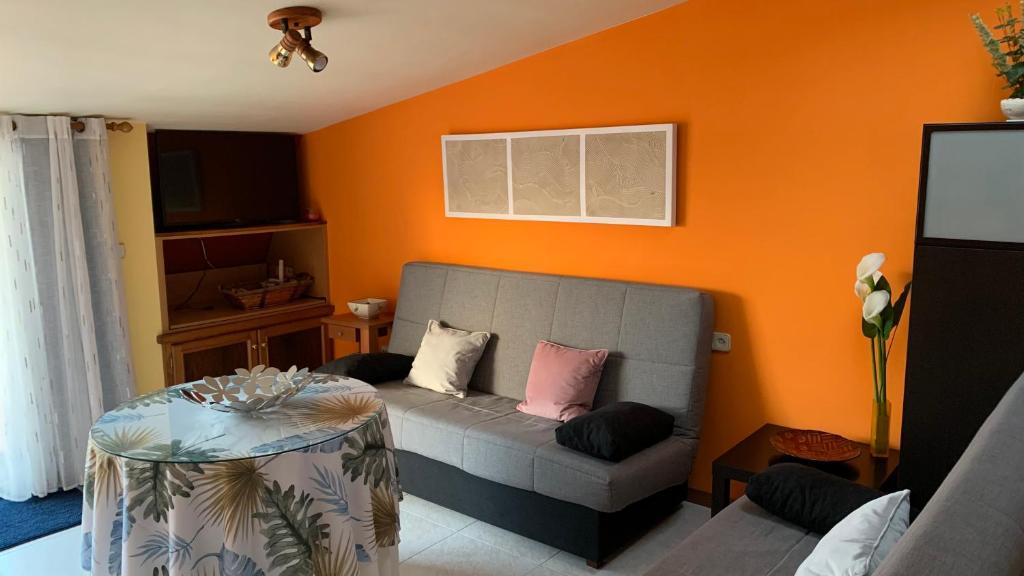 a living room with a couch and a table at Precioso ático en Playa América a 200 metros de la playa in Nigrán