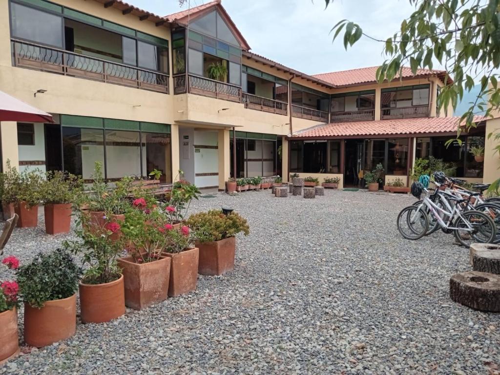 a courtyard in front of a building with potted plants at Hotel Villa Sofia in Nobsa