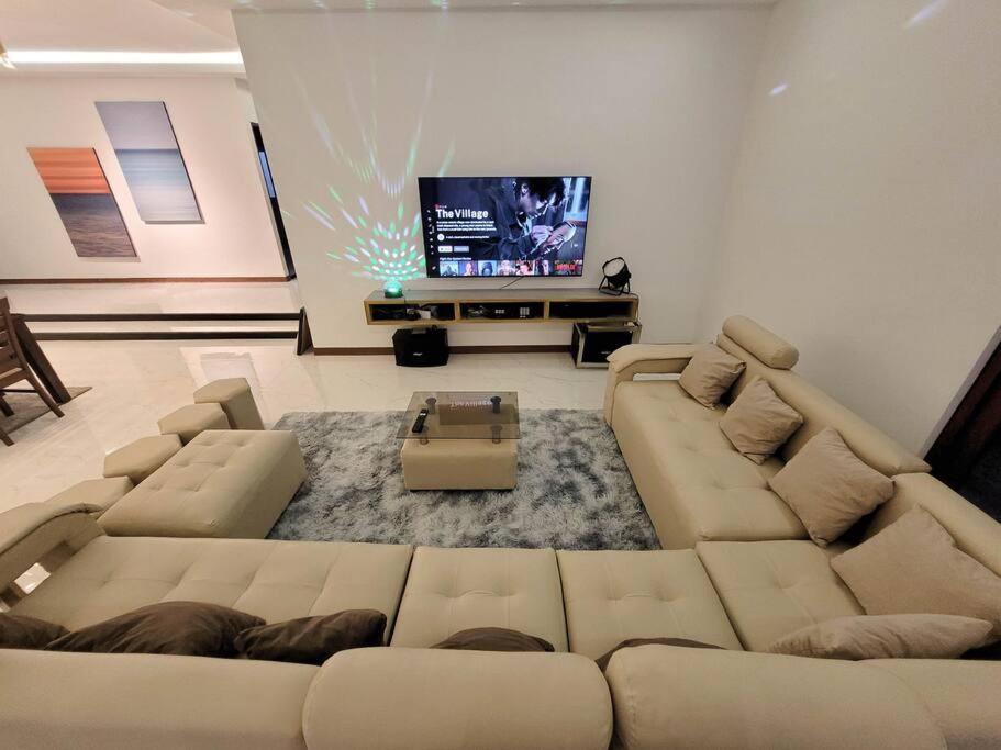 a living room with a couch and a flat screen tv at Jay's Villa 2 (Friendship) in Angeles