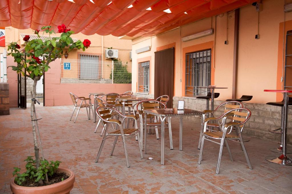 a patio with tables and chairs in a restaurant at Hostal El Rincón - Casa Marcos in Yepes