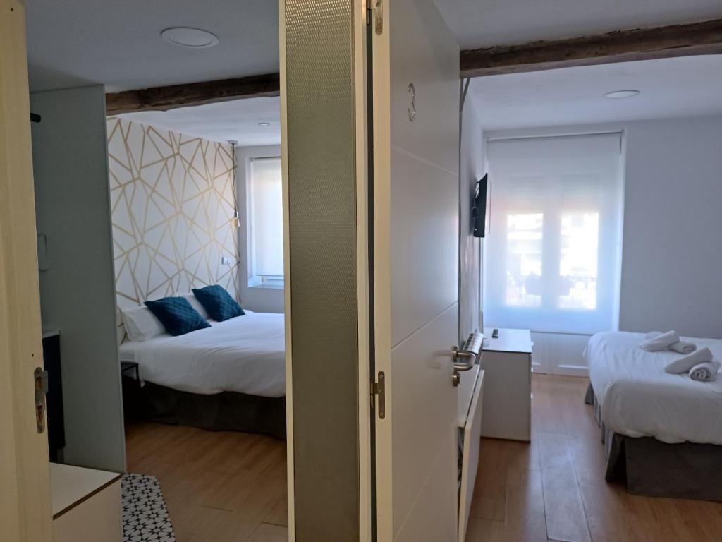 Postel nebo postele na pokoji v ubytování Rin Rooms