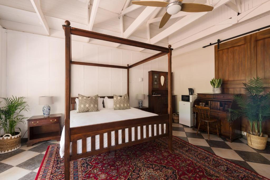 a bedroom with a canopy bed and a piano at House Falcon - close to ZAH in Pretoria