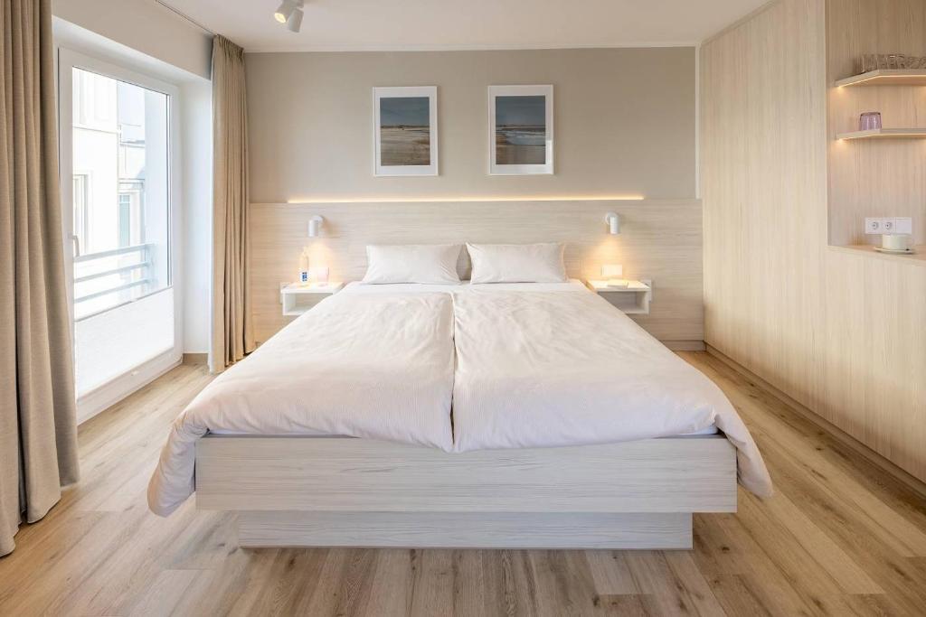 Postel nebo postele na pokoji v ubytování Hotel Stranddistel
