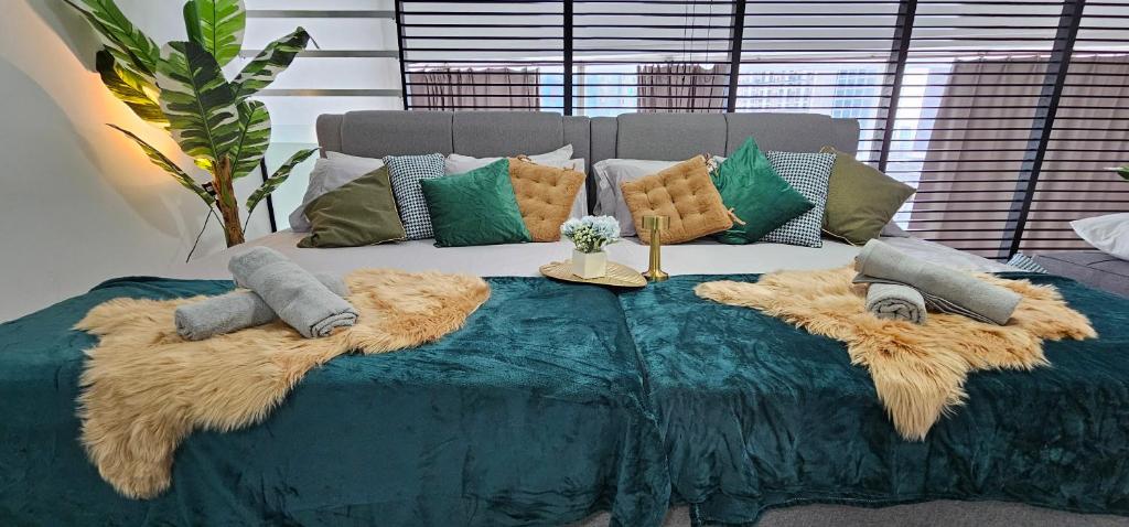 a bed with pillows on it with at Empire City M Tower in Petaling Jaya