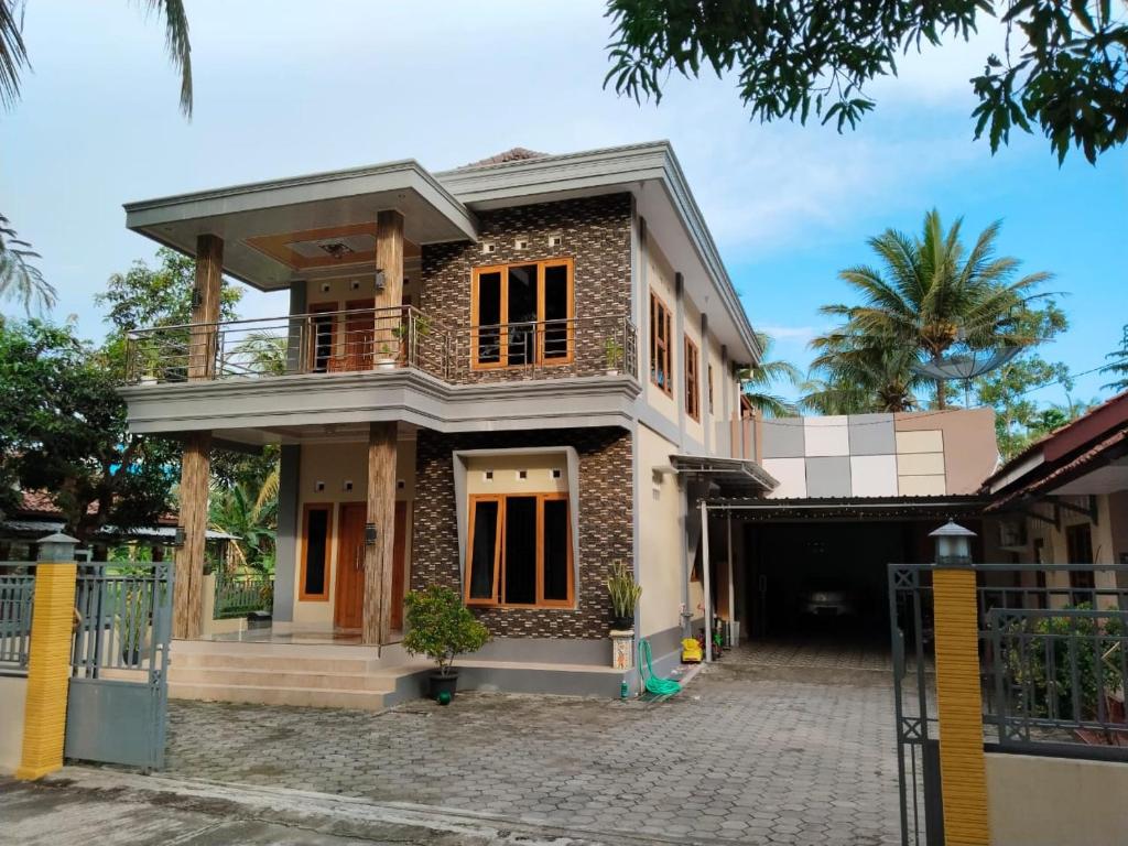 a house with a gate in front of it at Griya Delvin in Temon