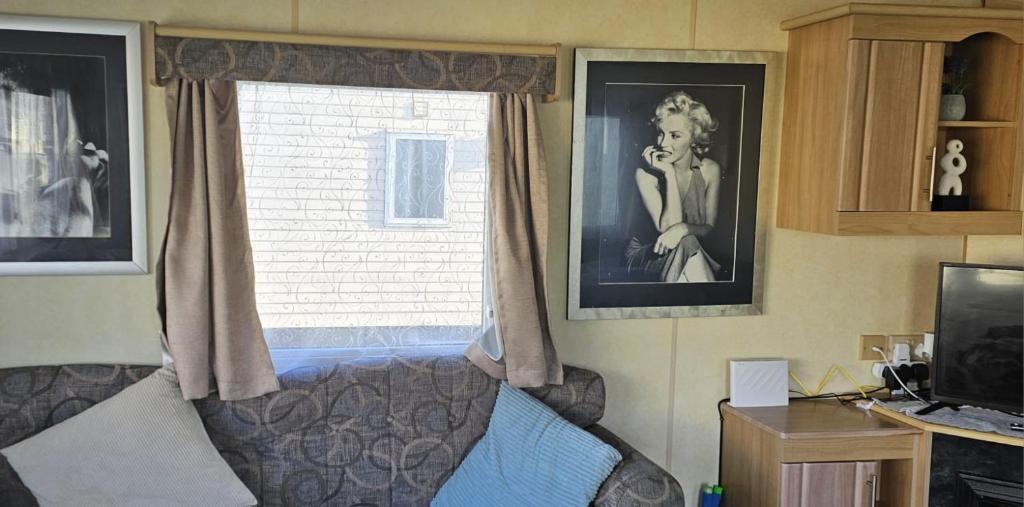 a bedroom with a bed and a window at J.R. Holiday Homes in Saint Osyth