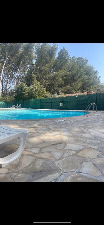 une piscine avec des toilettes blanches dans une cour dans l'établissement Studio Sanary bord de mer, à Sanary-sur-Mer