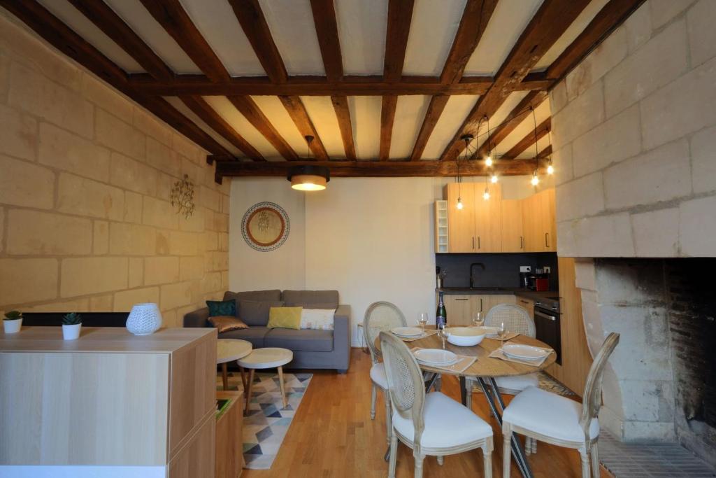 a kitchen and a living room with a table and chairs at Lovely T2 in the heart of Tours in Tours