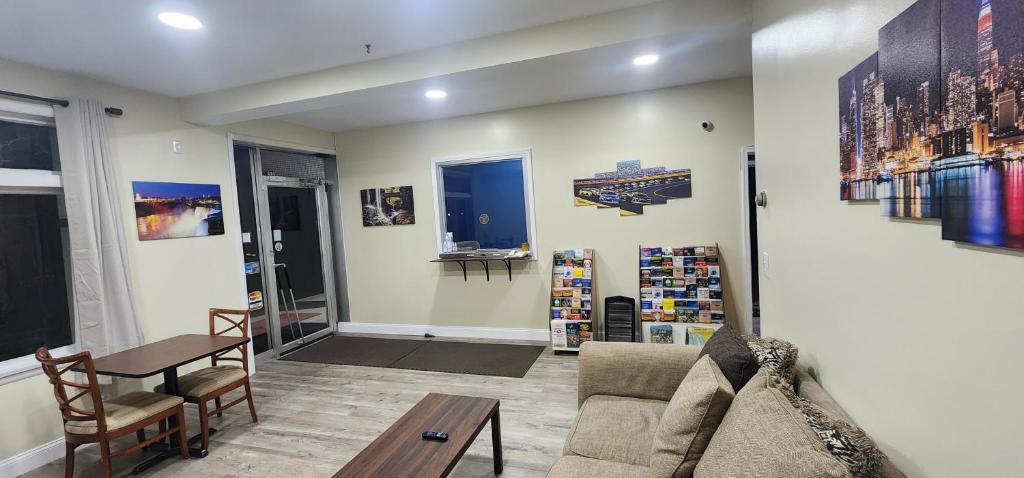 a living room with a couch and a table at Budget Inn Horseheads in Horseheads