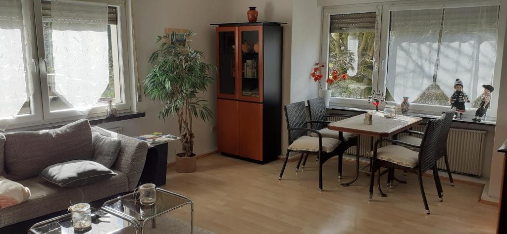 a living room with a couch and a table with chairs at Ferienwohnung an der Burg in Windeck