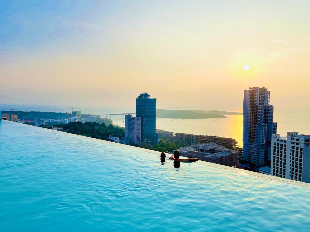 a infinity pool on the roof of a building with a city at AIR APARTMENTS Residence - Sihanoukville - 400m to boat pier in Sihanoukville