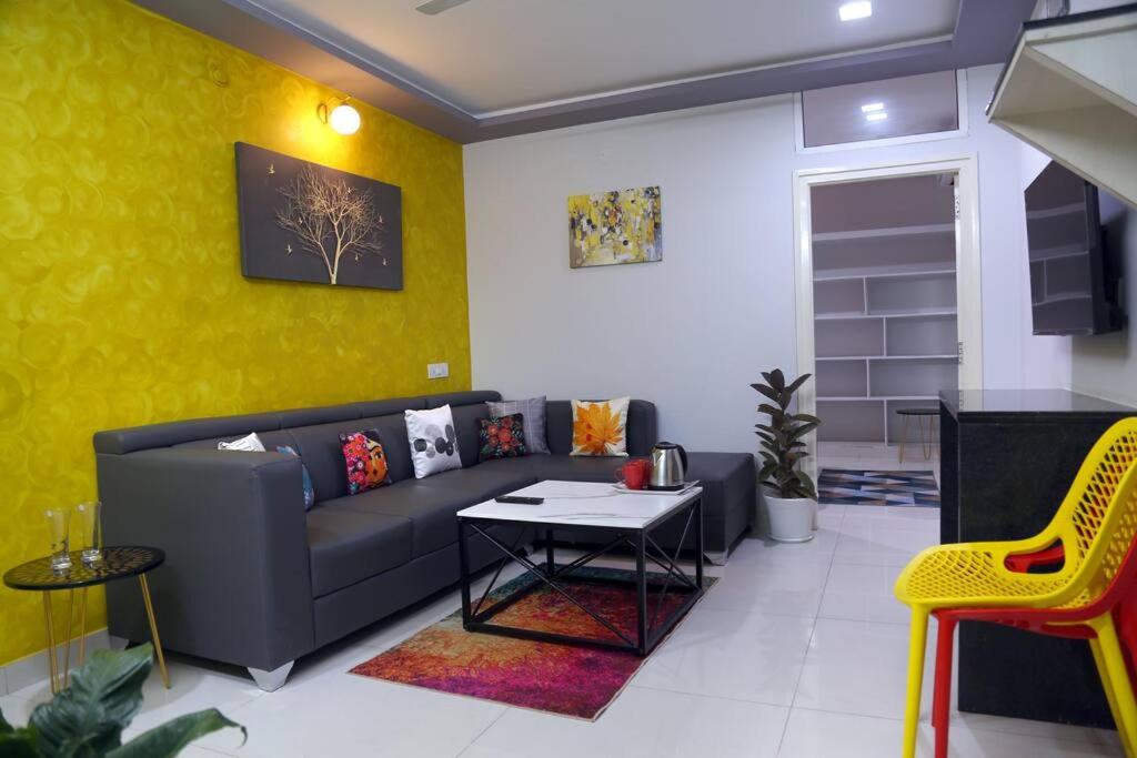 a living room with a couch and a table at MidTown-1BHK, Near AIG Hospital, Hitech City in Hyderabad