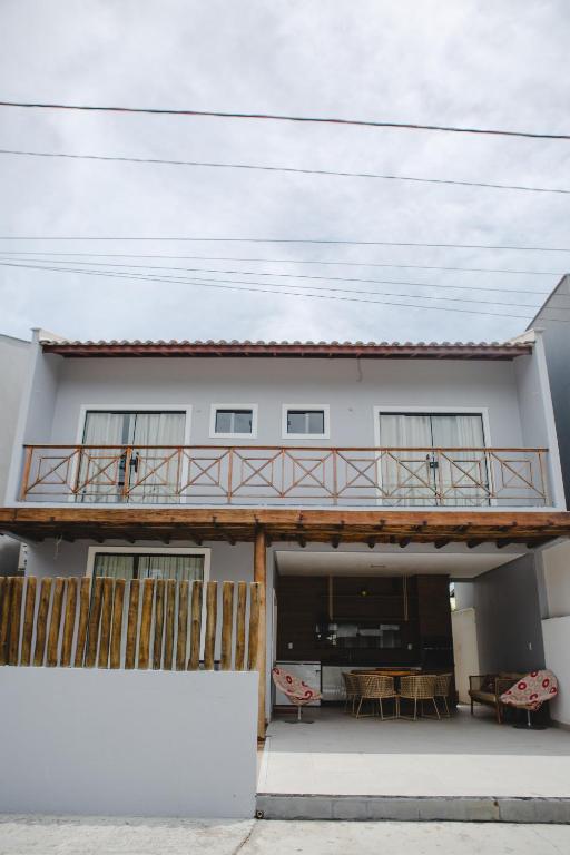 a house with a balcony with a table at Casa reserva boa vista in Barreirinhas