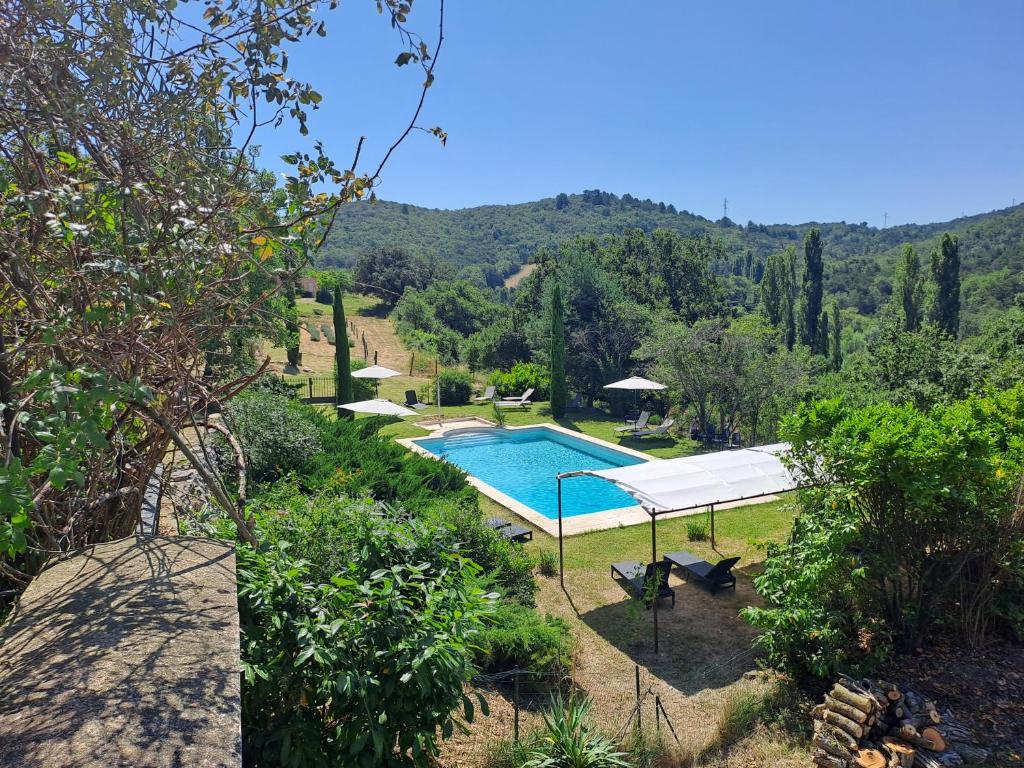 a swimming pool in a garden with a view at le relais d'elle in Niozelles