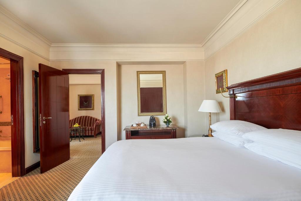a bedroom with a large bed and a desk at Intercontinental Cairo Citystars by IHG in Cairo