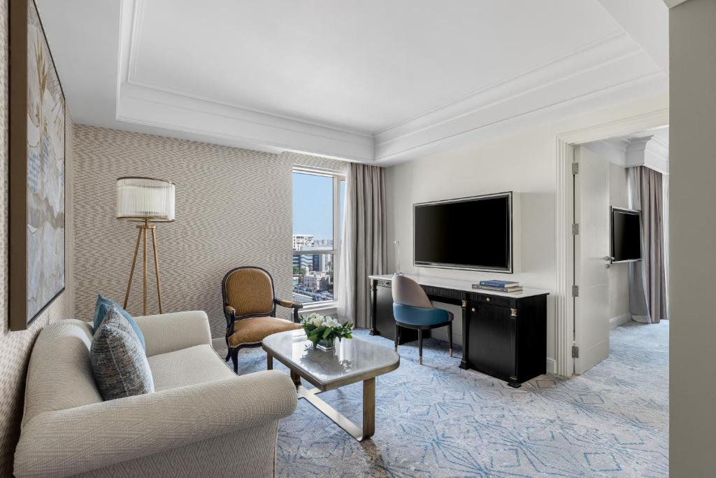 a living room with a couch and a television at Intercontinental Cairo Citystars by IHG in Cairo
