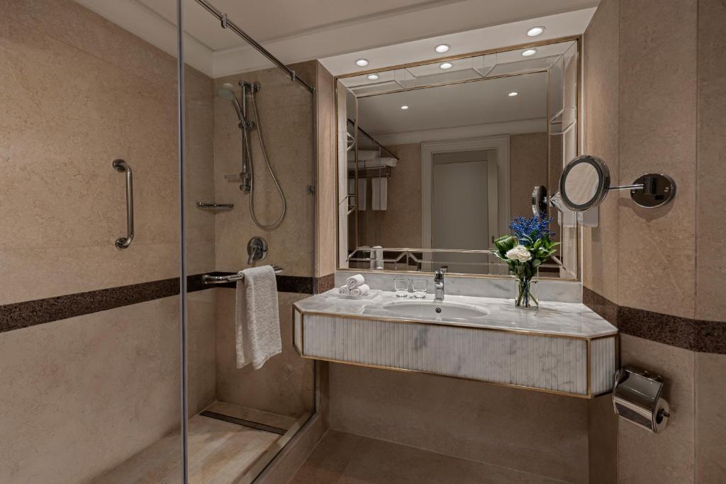 a bathroom with a sink and a shower with a mirror at Intercontinental Cairo Citystars by IHG in Cairo