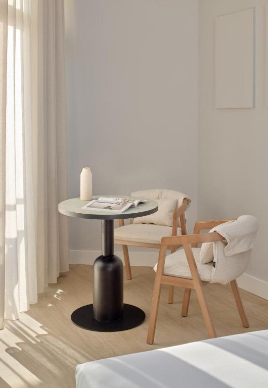 a table and a chair in a room at Meliá Lloret de Mar in Lloret de Mar