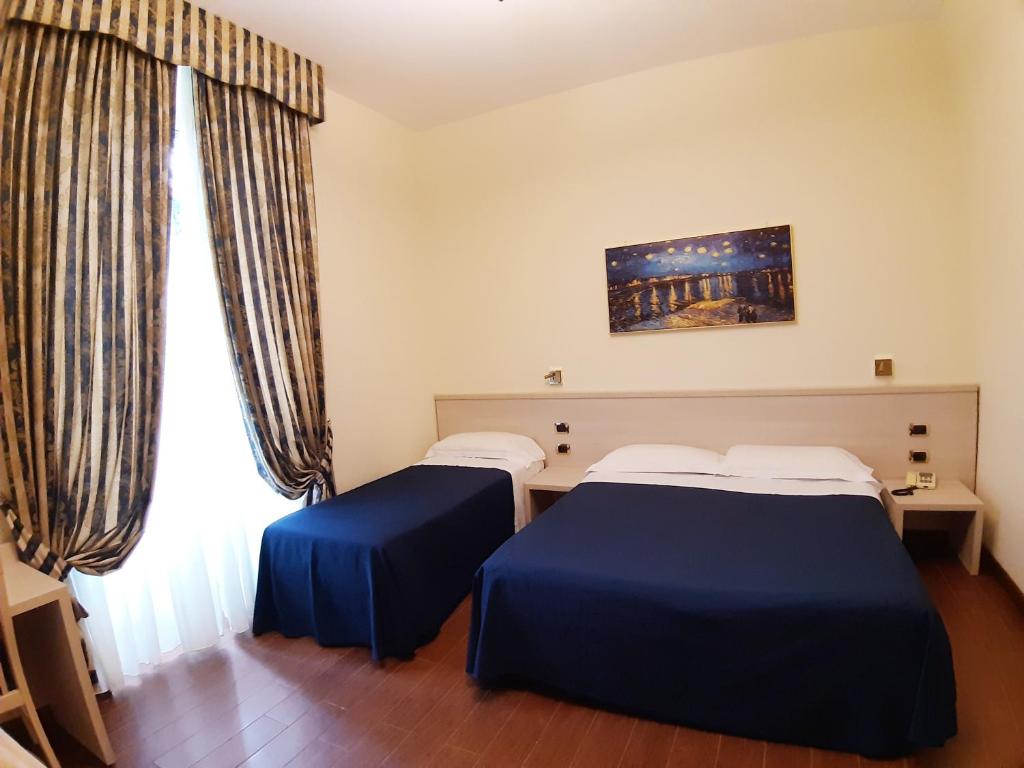 Postel nebo postele na pokoji v ubytování Hotel Mariano