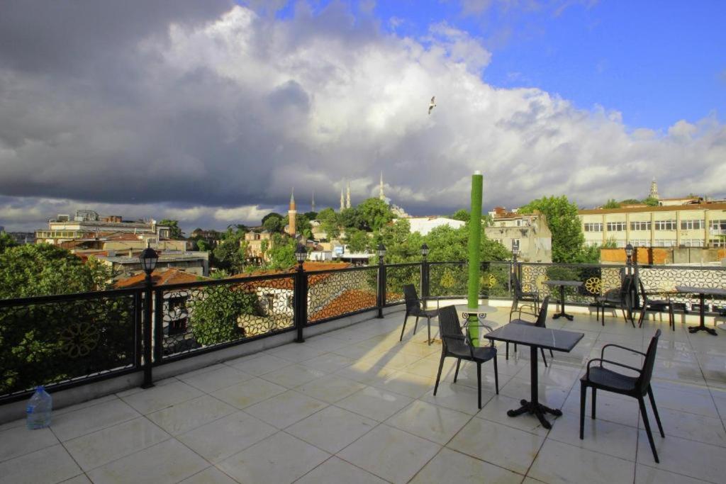 a patio with chairs and a table on a balcony at Güler Palas İstanbul Hotel in Istanbul