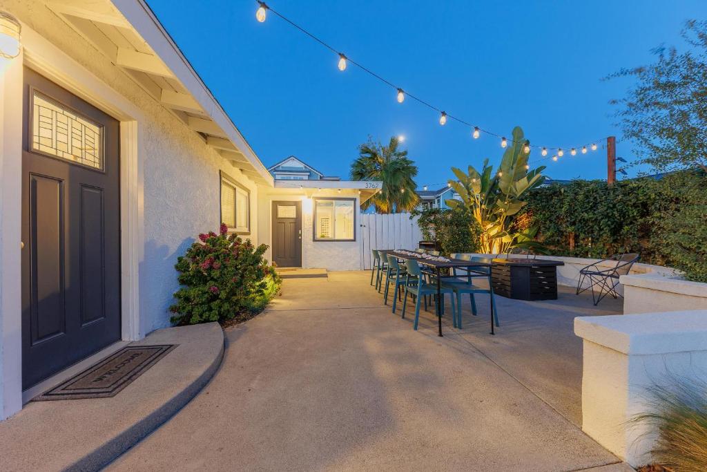 a patio with a table and chairs on a house at Charming Beach Bungalows - 4BR, Sleeps 10, Pets OK in Carlsbad
