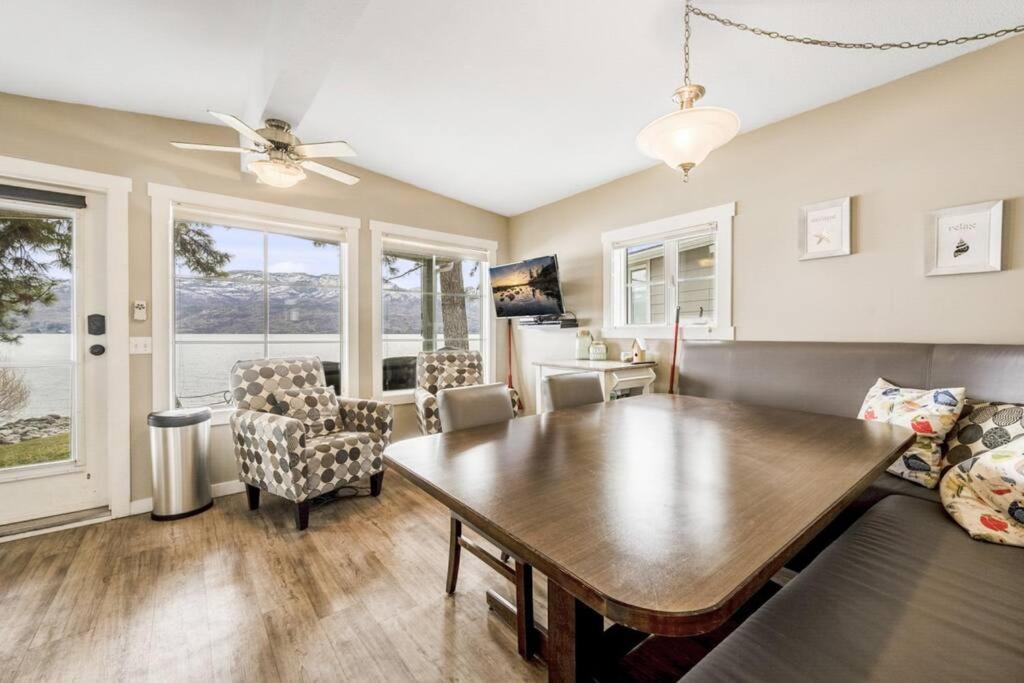 a living room with a wooden table and chairs at Secluded Cabin On The Lake #7 in West Kelowna