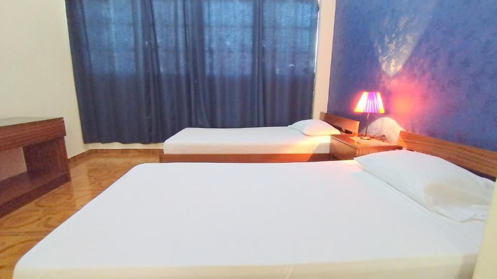Postel nebo postele na pokoji v ubytování Residencial Amarante