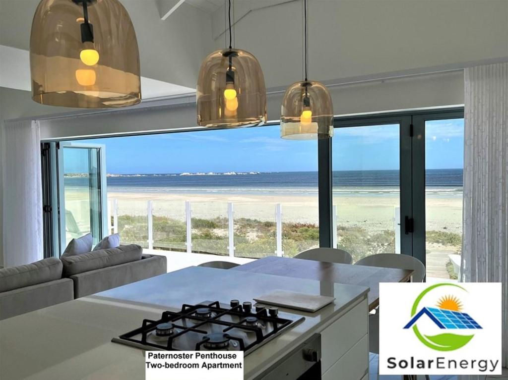 a kitchen with a view of the beach at Paternoster Penthouse - Solar in Paternoster