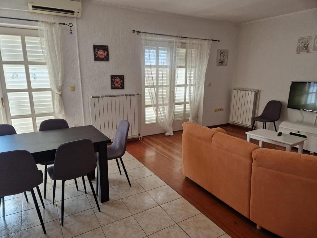 a living room with a couch and a table at Apartment Marta in Rab