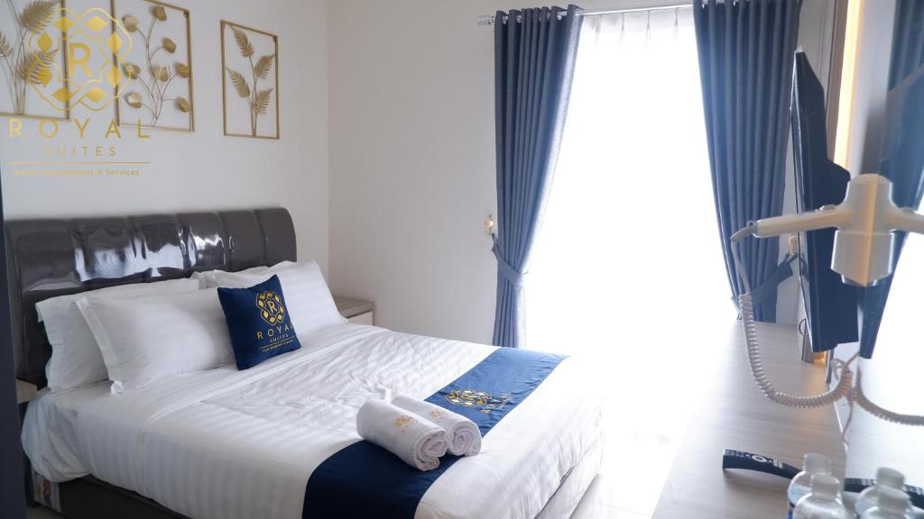 a bedroom with a bed with towels on it at Royal Suites Studio 28th Floor - Citra Plaza Nagoya Apartment in Jodoh