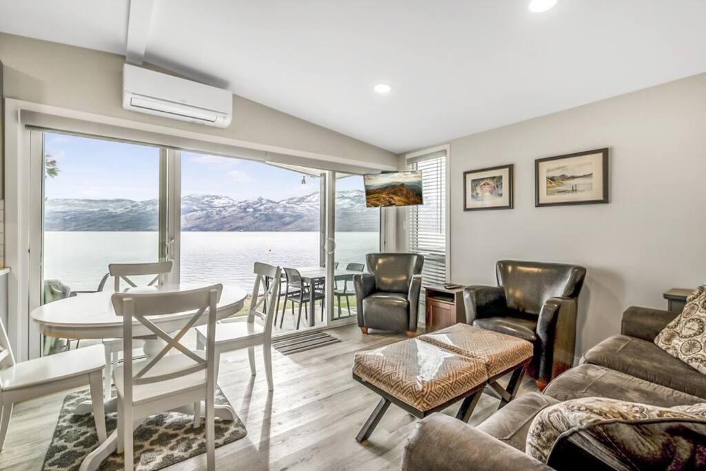 a living room with a view of the water at Family-friendly Cottage with amazing views in West Kelowna