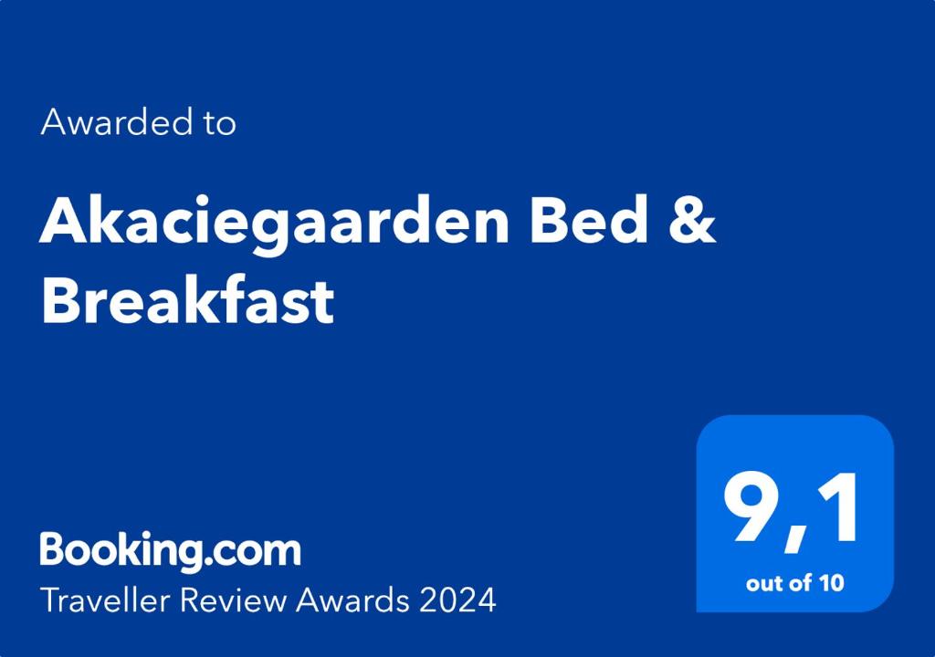 a blue sign that saysaaaarden bed and breakfast at Akaciegaarden Bed & Breakfast in Hårlev