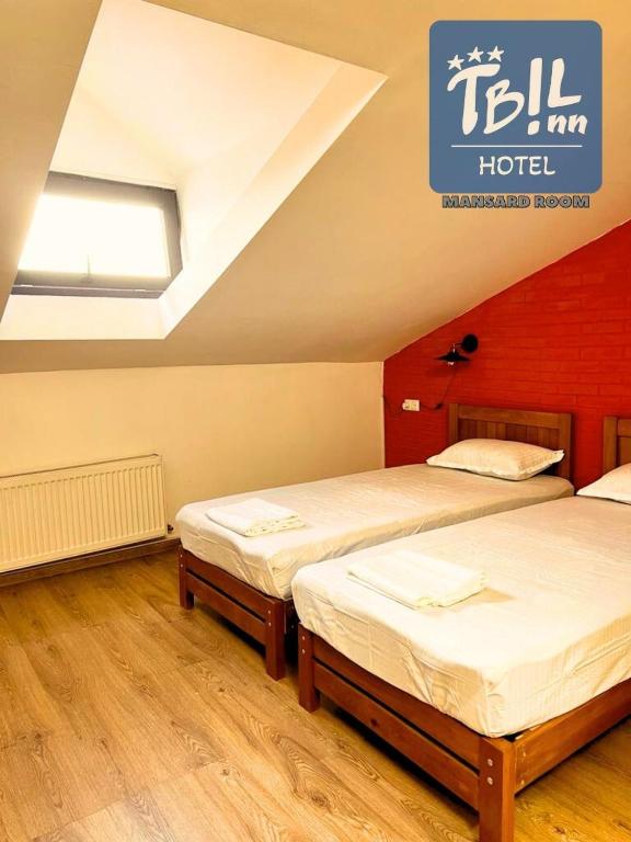 Postel nebo postele na pokoji v ubytování Tbil Inn Hotel